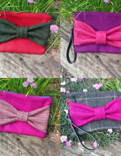 Tweed clutch bags with tweed bow to front, pinks, greys, purple and red with leather wrist strap.